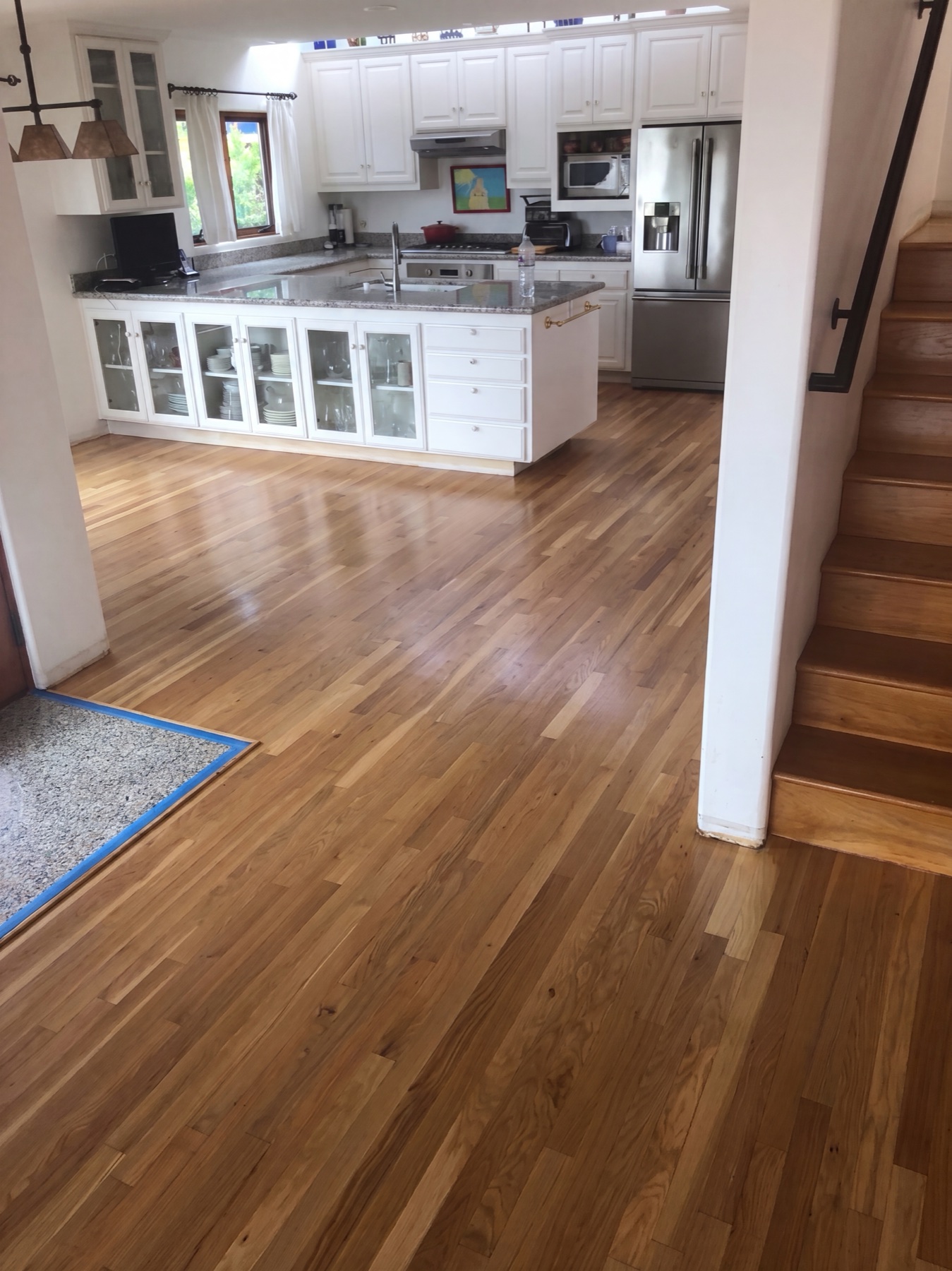 The same kitchen with a flawless, freshly finished light oak floor